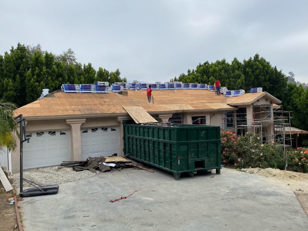 Roof tear-off removing old tile on a Beverly Hills home by Ikon Roofing